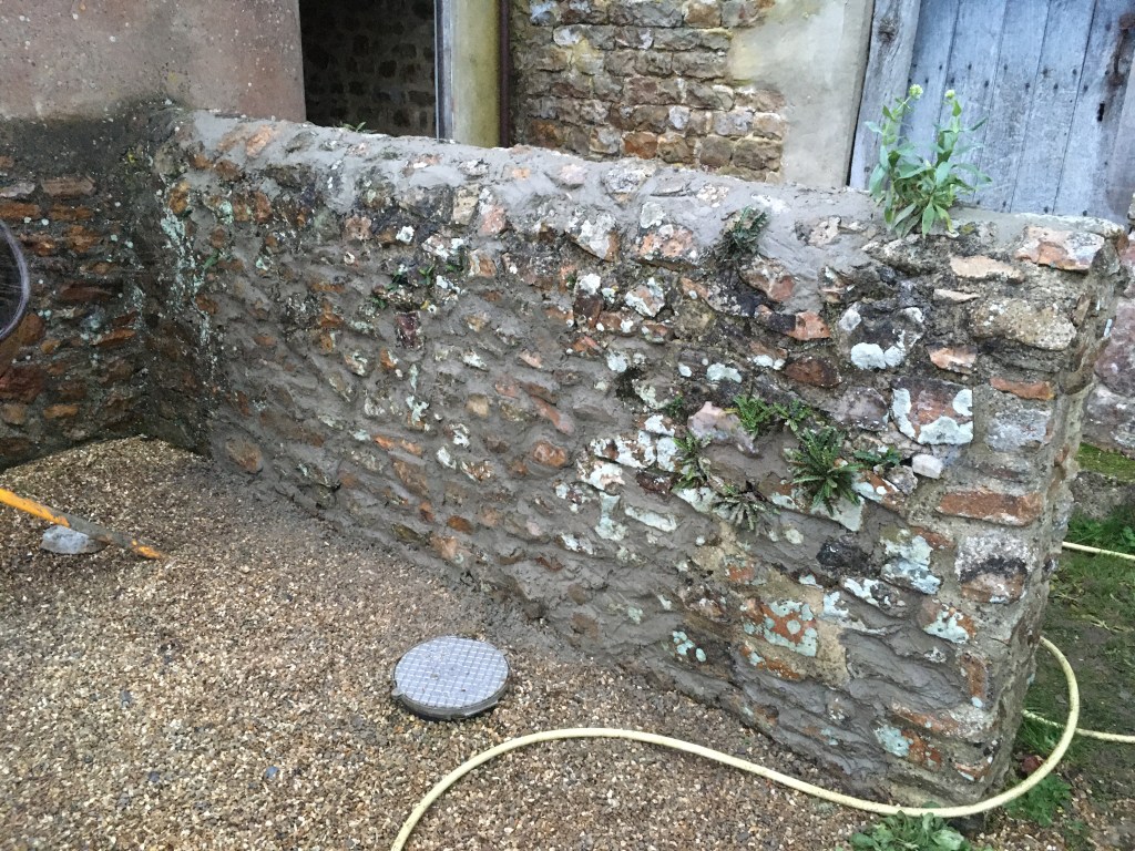 The first finished wall (some greenery left to maintain the rustic look)!!